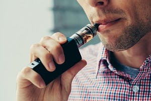 Man inhaling vapor from an electronic cigarette