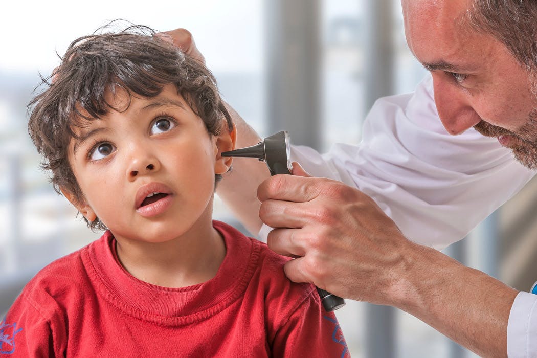 Doctor checking a child's hearing