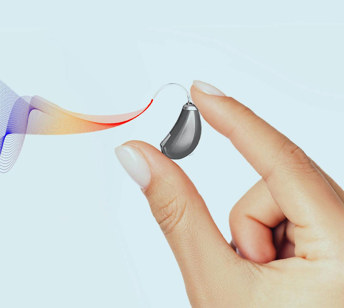 Hand holding an hearing aid