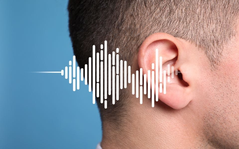 Close-up of a man's ear with a sound wave illustration to show the concept of hearing loss